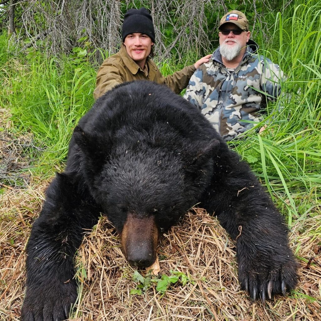 two hunters and hunted bear