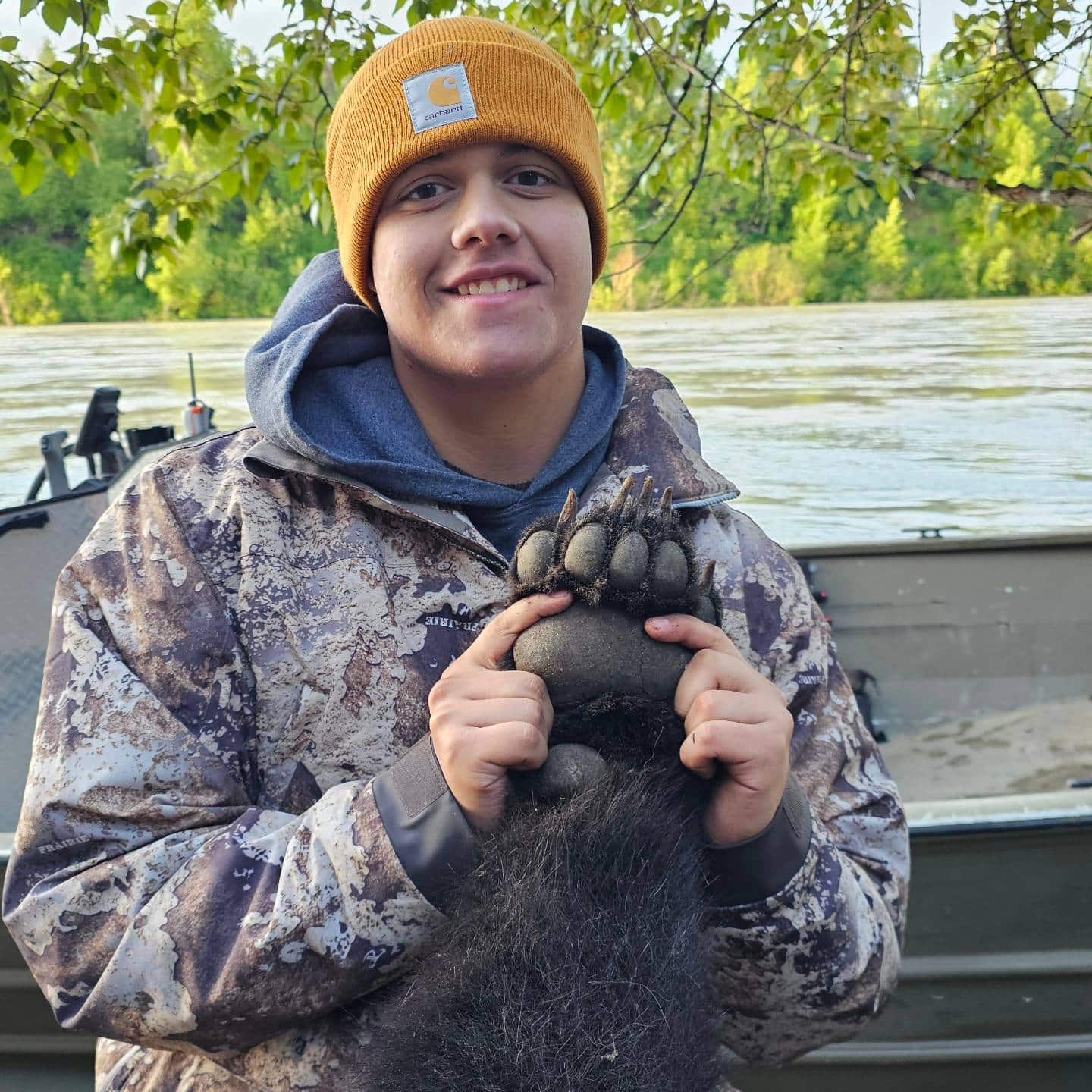 young man holding bear paw