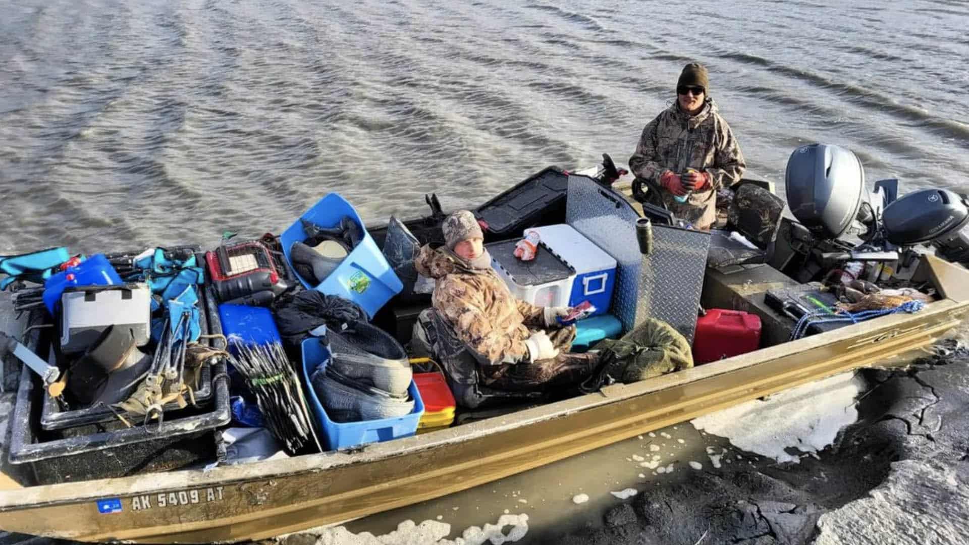 hunters with gear on a boat