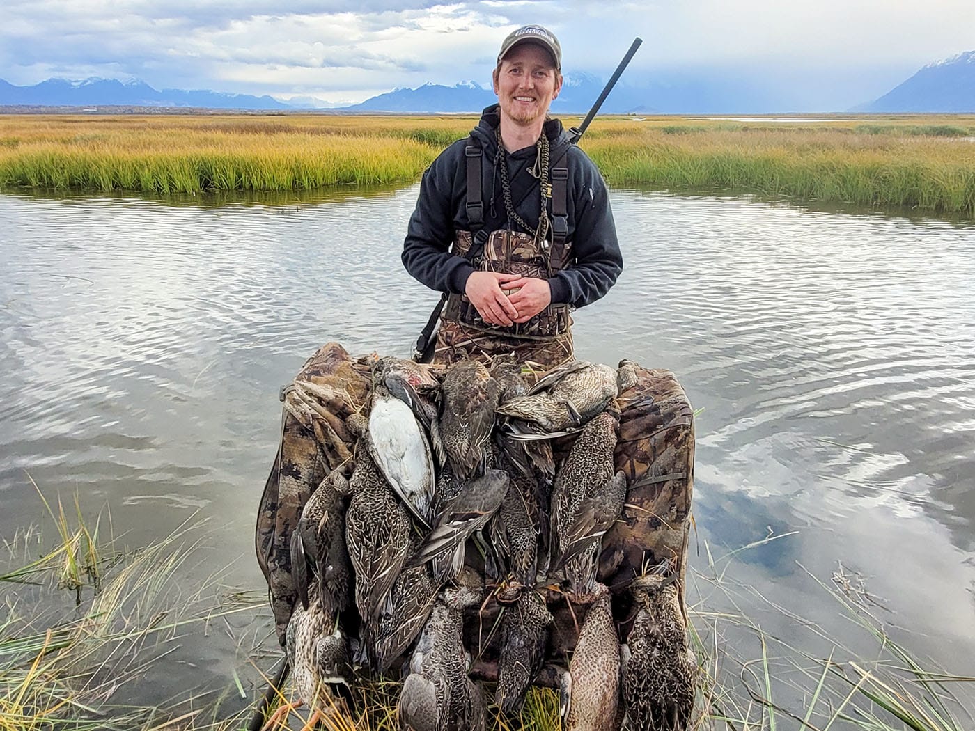 hunter with waterfowl hunt in the river