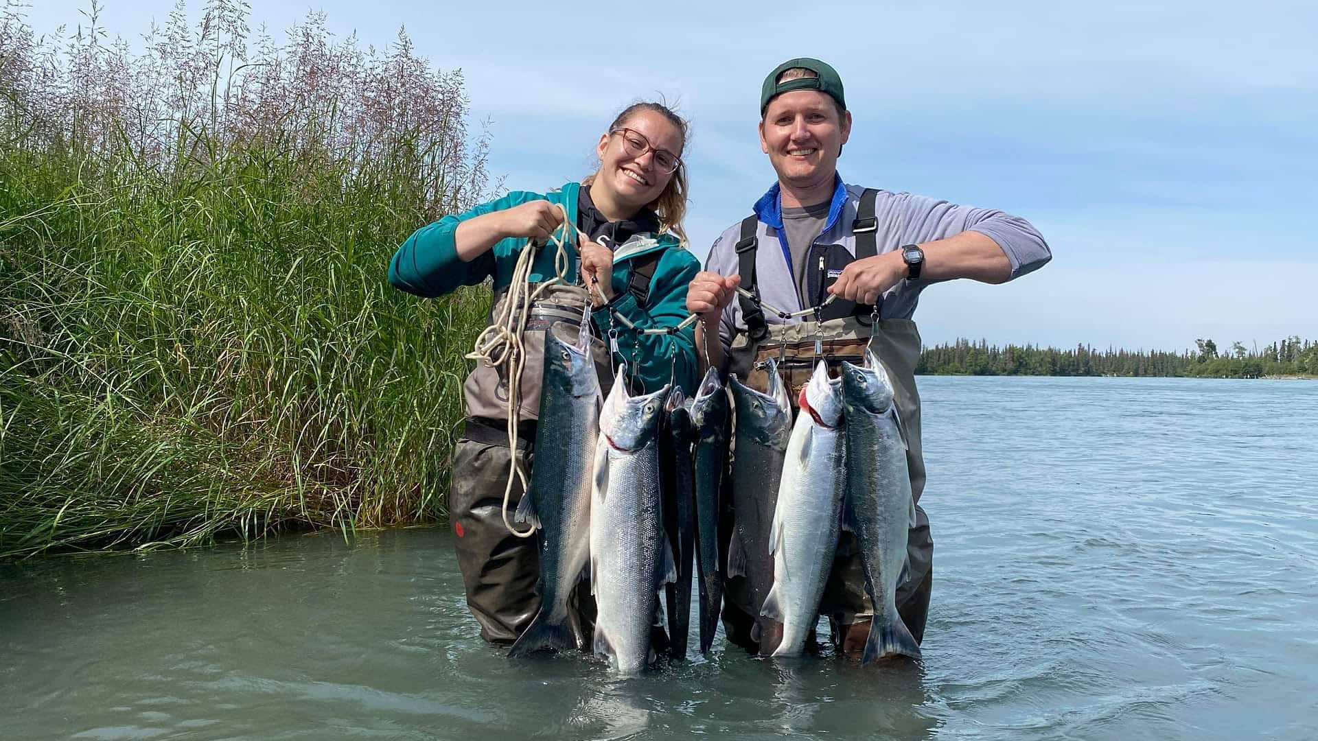 couple holding their salmon catch